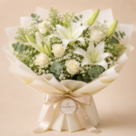 White Serenity Lilies Bouquet Delivery in Dhaka White Serenity Lilies is a graceful sympathy flower bouquet designed to express peace, comfort, and heartfelt condolences. This elegant arrangement features fresh white lilies, white roses, baby’s breath, and soft eucalyptus foliage, beautifully wrapped in premium paper with a refined presentation. It is a thoughtful floral tribute suitable for condolence visits, memorial gestures, and sending support to loved ones during difficult times. At Pikooly Bangladesh, we carefully select fresh flowers to create meaningful sympathy bouquets that reflect purity, respect, and remembrance. Each bouquet is hand-arranged shortly before delivery to ensure freshness, beauty, and a calm elegant look. Whether you want to offer comfort to a grieving family, send a respectful condolence gift, or express sincere support, White Serenity Lilies is a timeless and compassionate choice. Why Choose Our White Serenity Lilies Bouquet Fresh white lilies and white roses Elegant sympathy presentation Premium bouquet wrapping Handcrafted by experienced florists Suitable for condolence and memorial gifting Soft fragrance with a peaceful appearance Carefully arranged for a calm and respectful look White Lily Meaning and Beauty What Do White Lilies Symbolize? White lilies symbolize purity, peace, innocence, and the peaceful remembrance of a loved one. They are one of the most meaningful flowers for sympathy and condolence arrangements because of their calm and graceful appearance. Why White Lilies Are Popular in Sympathy Bouquets White lilies are widely used in condolence bouquets because they create a dignified and comforting impression. Their elegant petals and gentle fragrance help convey compassion, support, and heartfelt respect. Bouquet Includes White lilies White roses Baby’s breath Eucalyptus foliage Premium wrapping Categories Sympathy & Condolence, White Flower Bouquets, Lily Bouquets, Condolence Flowers, Same Day Flowers, Elegant Flower Bouquets