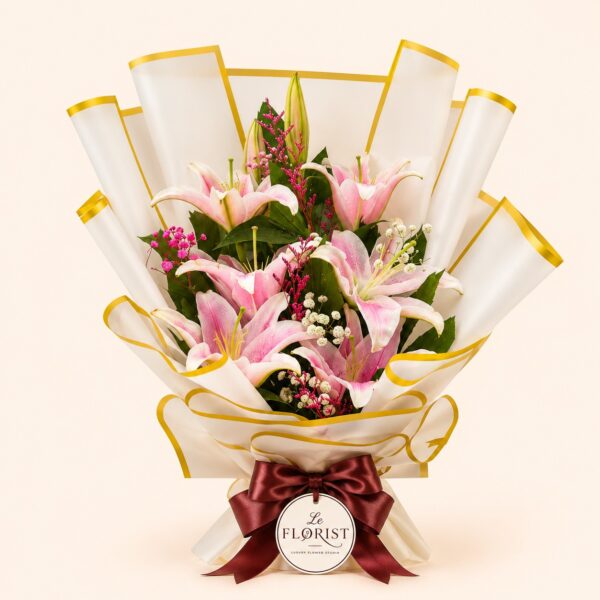 Pink lily bouquet in white and gold edged wrapping