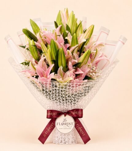 Premium pink lily bouquet with many fresh buds in white mesh wrapping